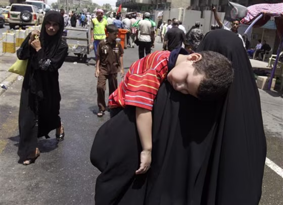 Shiite pilgrims walk toward the Imam Moussa al-Kadhim shrine for the annual commemoration of the saint's death, in the Shiite district of Kazimiyah, in Baghdad, Iraq, on Sunday.